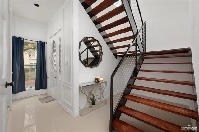 a view of entryway and hall with wooden floor