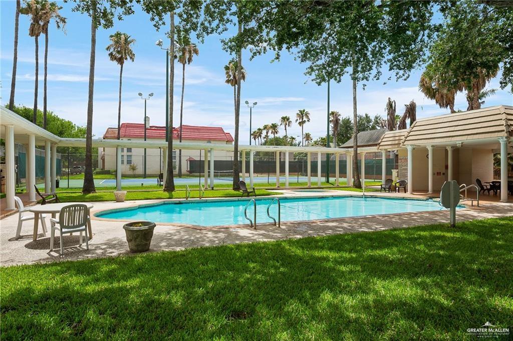 3100 South 2nd Street, Unit 29 McAllen, TX 78503 - Photo 23 of 23 a view of swimming pool with lawn chairs and palm tree