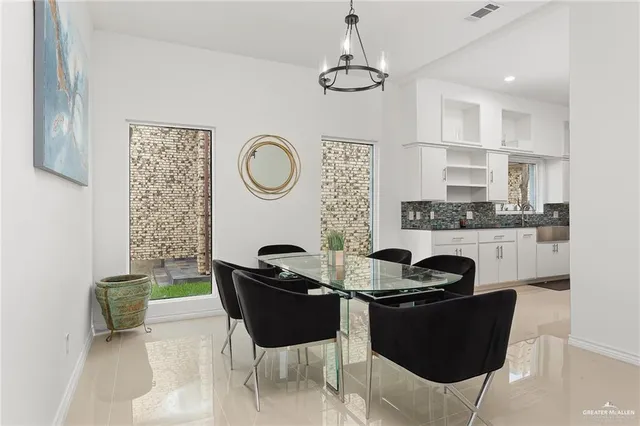 a dining room with furniture and a chandelier