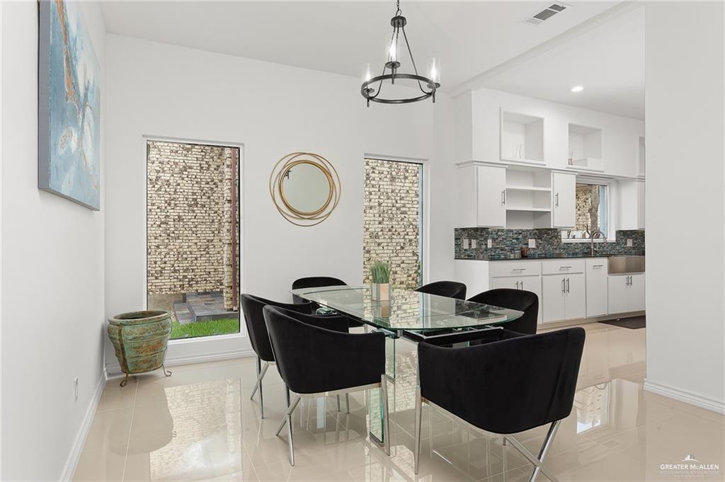 3100 South 2nd Street, Unit 29 McAllen, TX 78503 - Photo 4 of 23 a dining room with furniture and a chandelier