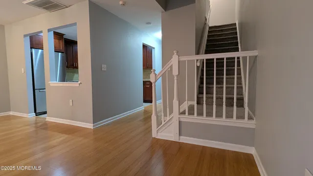 a view of wooden floor and staircase in a room