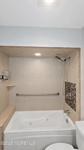 a bathroom with a bathtub and shower