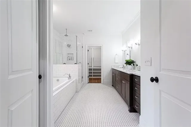 a spacious bathroom with a double vanity sink and shower
