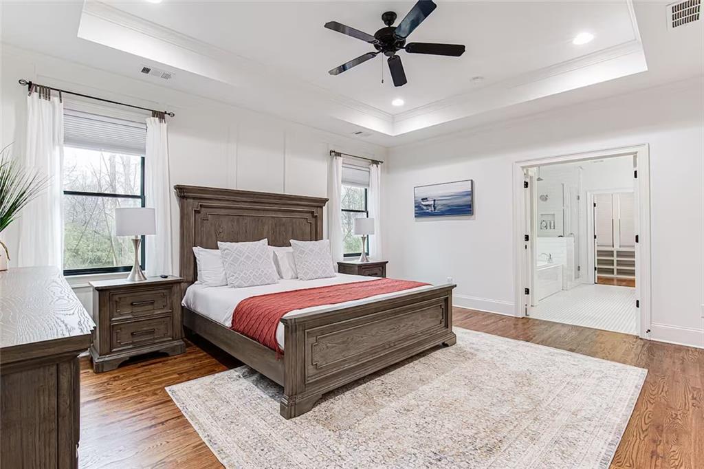 222 Kirkwood Road Northeast Atlanta, GA 30317 - Photo 18 of 21 a spacious bedroom with a bed a dresser and a window