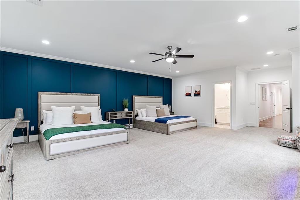 222 Kirkwood Road Northeast Atlanta, GA 30317 - Photo 20 of 21 a spacious bedroom with a bed and a chandelier