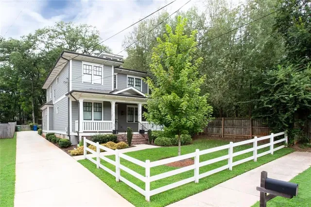 a front view of a house with a yard table and chairs