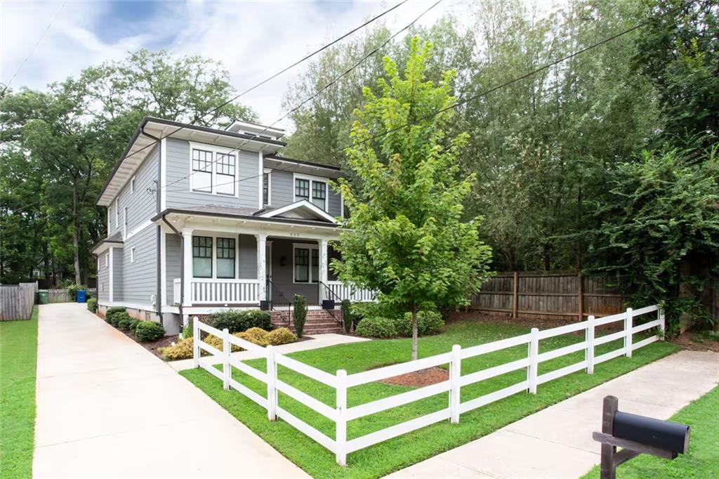 222 Kirkwood Road Northeast Atlanta, GA 30317 - Photo 2 of 21 a front view of a house with a yard table and chairs
