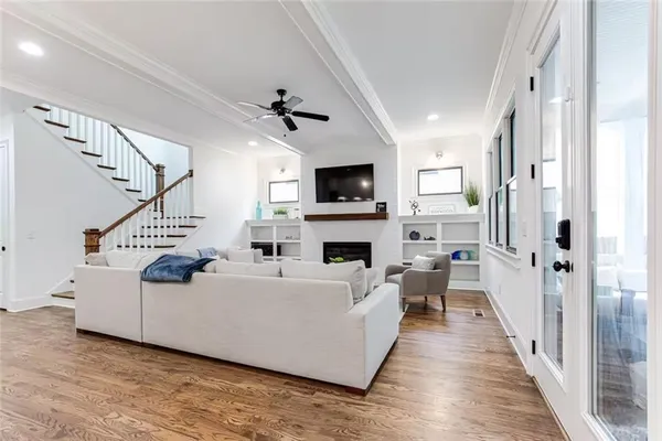a living room with furniture a fireplace and a flat screen tv