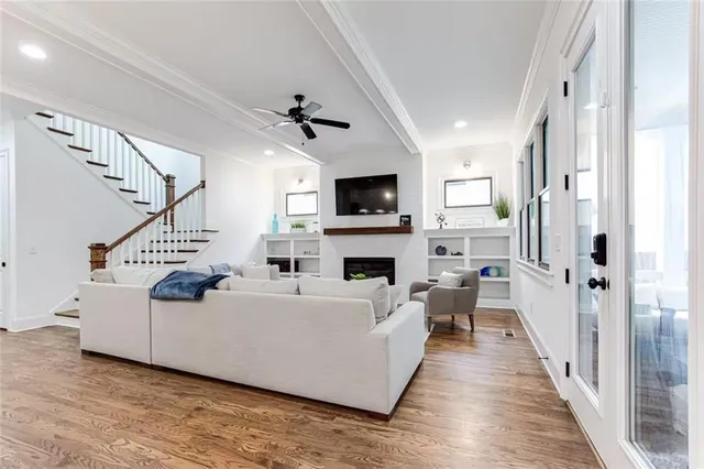 a living room with furniture a fireplace and a flat screen tv