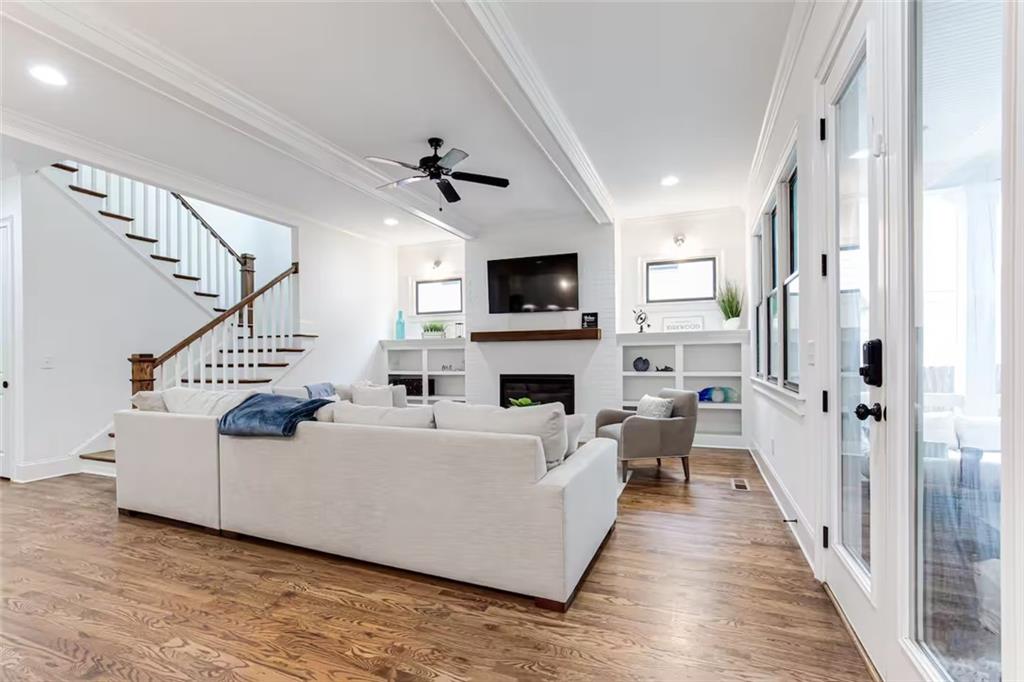 222 Kirkwood Road Northeast Atlanta, GA 30317 - Photo 4 of 21 a living room with furniture a fireplace and a flat screen tv