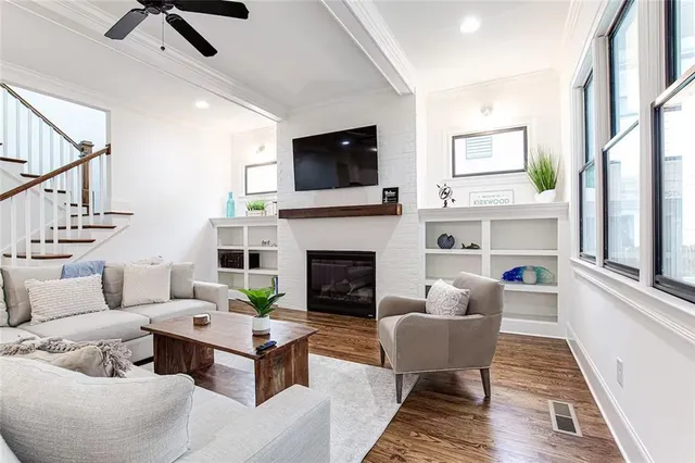 a living room with furniture fireplace and flat screen tv