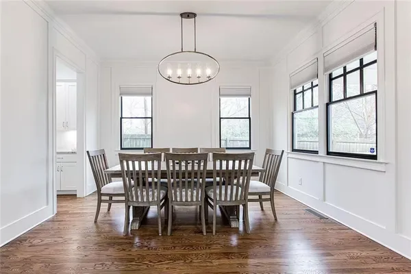 a view of a dining room with furniture window and wooden floor