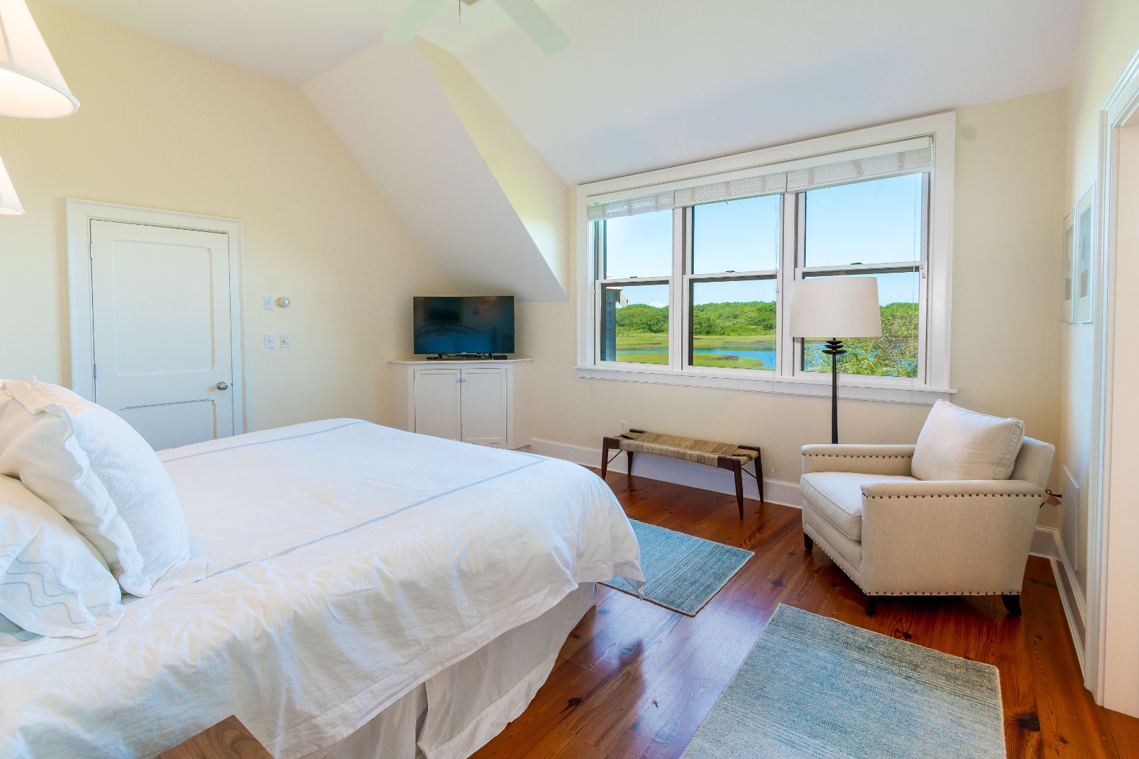 240 Polpis Road Nantucket, MA 02554 - Photo 18 of 45 a bedroom with a bed a couch and a window