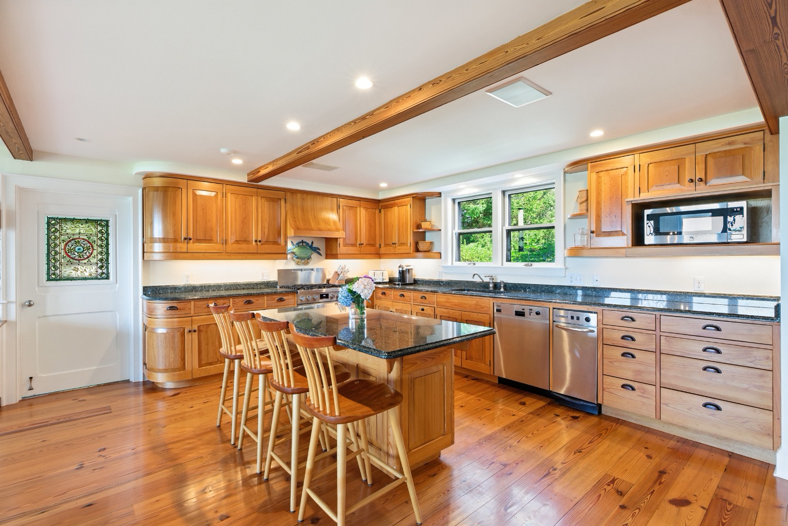 240 Polpis Road Nantucket, MA 02554 - Photo 7 of 45 a kitchen with granite countertop lots of white cabinets and wooden floor