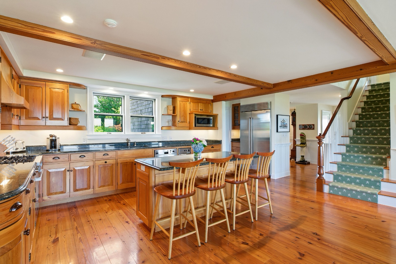240 Polpis Road Nantucket, MA 02554 - Photo 8 of 45 a kitchen with stainless steel appliances granite countertop table chairs stove and wooden floor
