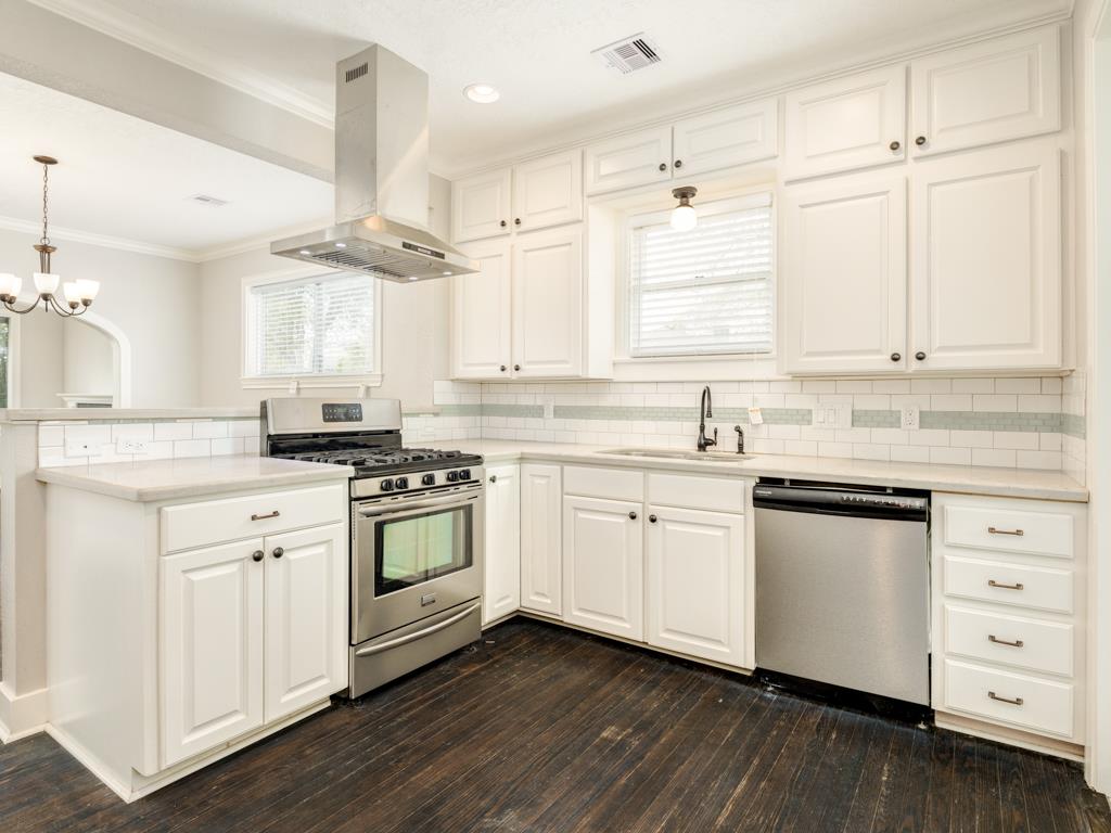 4528 Avenue R 1/2 Galveston, TX 77551 - Photo 14 of 22 a kitchen with granite countertop white cabinets and white appliances