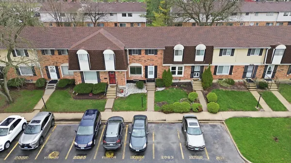 an aerial view of a house with garden space and street view