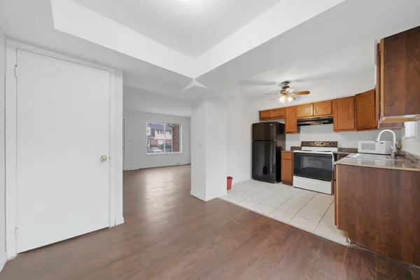 a kitchen with stainless steel appliances granite countertop a refrigerator and a stove top oven