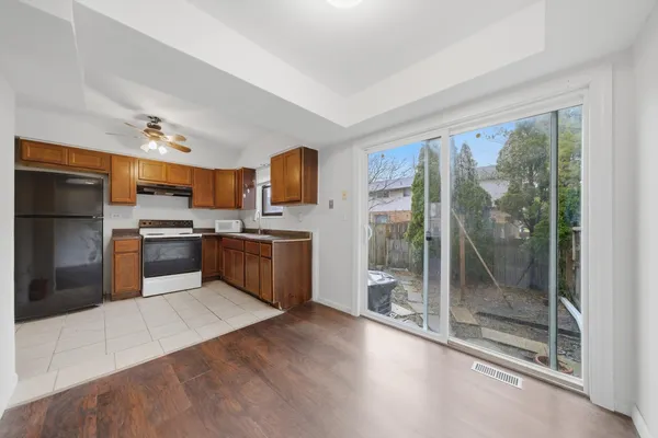 a kitchen with stainless steel appliances a refrigerator a sink a stove top oven a sink and cabinets