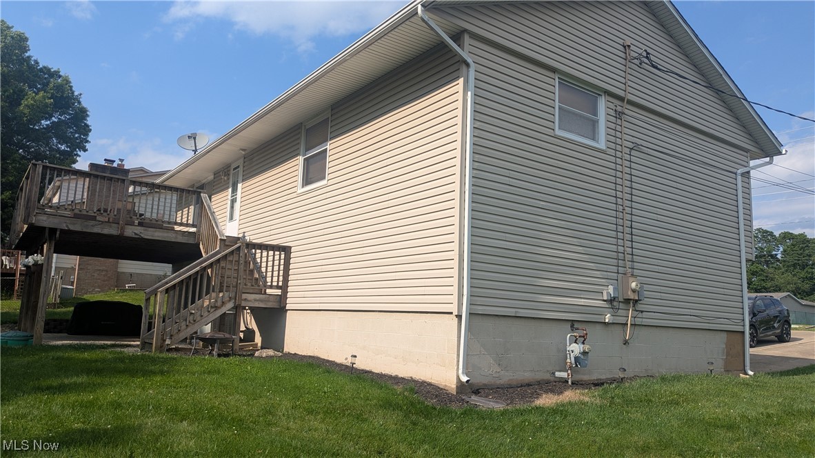 290 Leatherman Road Wadsworth, OH 44281 - Photo 40 of 43 View of side of property with a lawn, a deck, and stairs