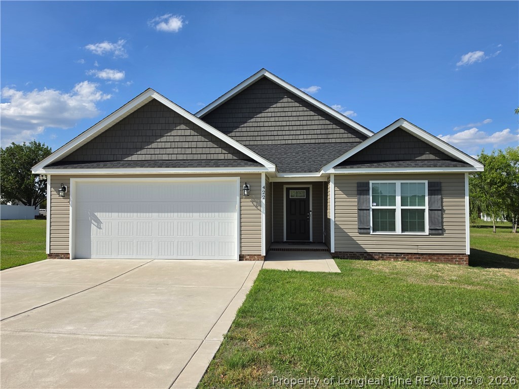 422 Mitchell Farm Road Goldsboro, NC 27530 - Photo 1 of 28 a front view of a house with a garden