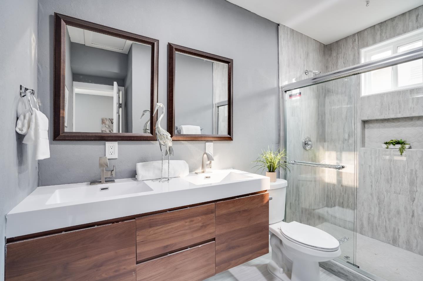 460 Dixon Road Milpitas, CA 95035 - Photo 17 of 36 a bathroom with a toilet a sink a mirror and a shower