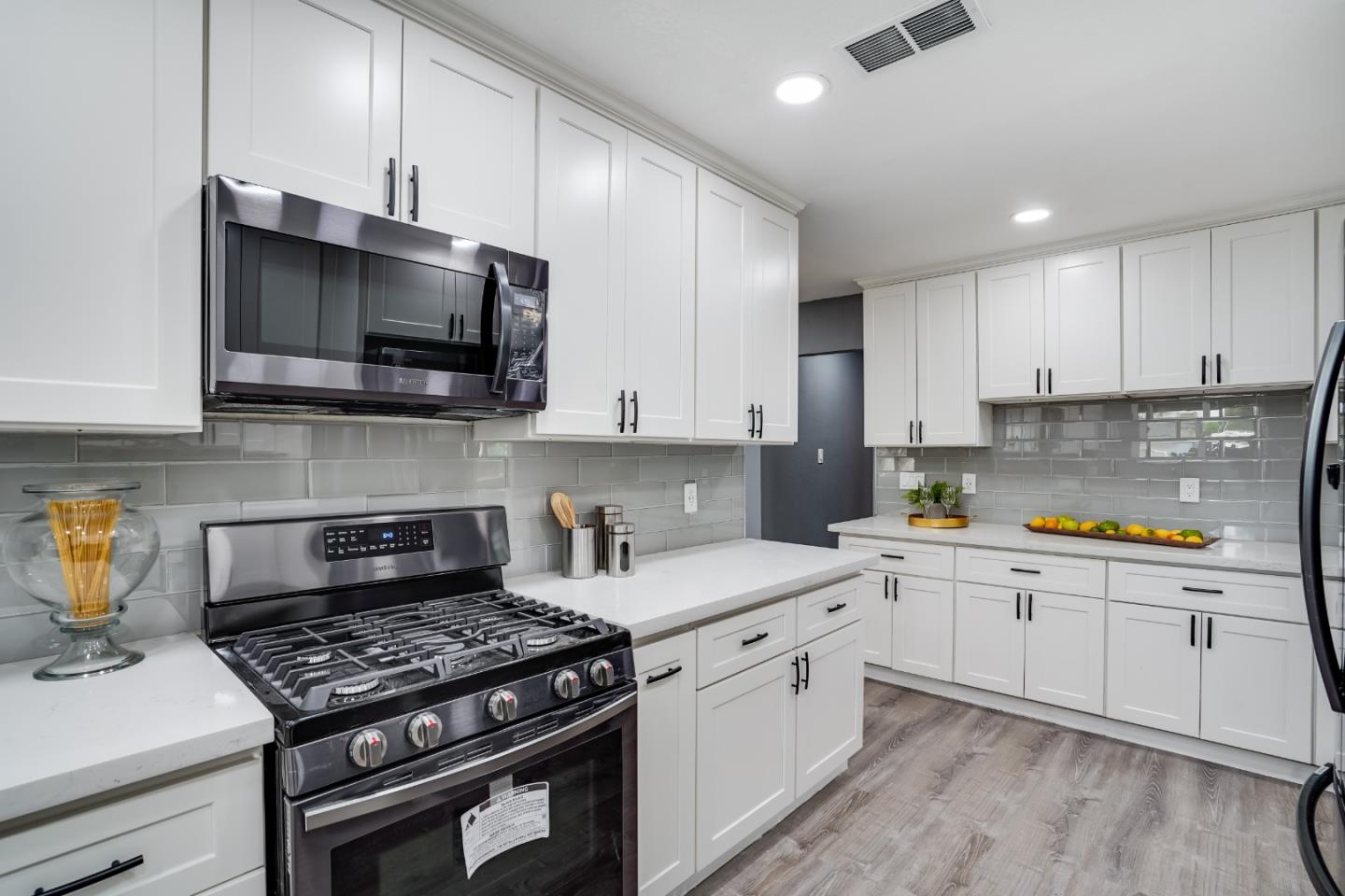 460 Dixon Road Milpitas, CA 95035 - Photo 9 of 36 a kitchen with stainless steel appliances a sink a stove top oven a counter space and cabinets