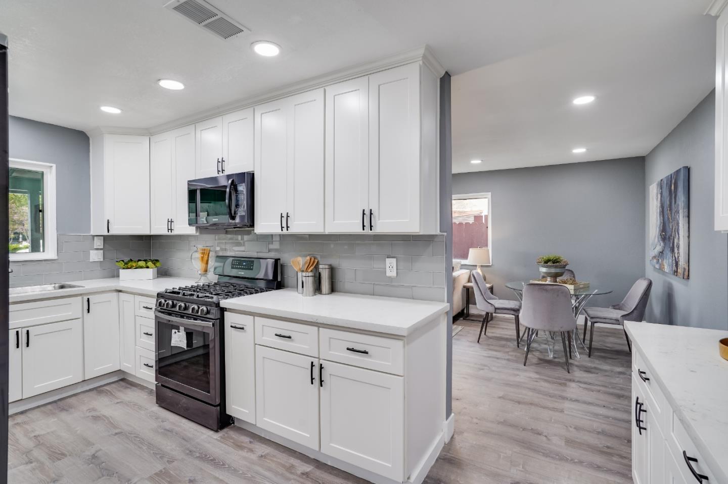 460 Dixon Road Milpitas, CA 95035 - Photo 10 of 36 a kitchen with a sink white cabinets and white appliances