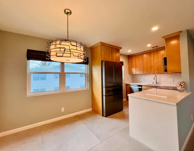 a view of a kitchen with refrigerator and microwave