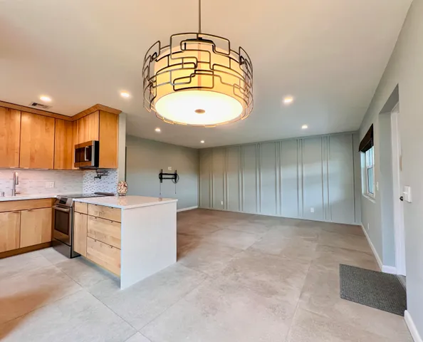 a kitchen with a sink a stove and cabinets