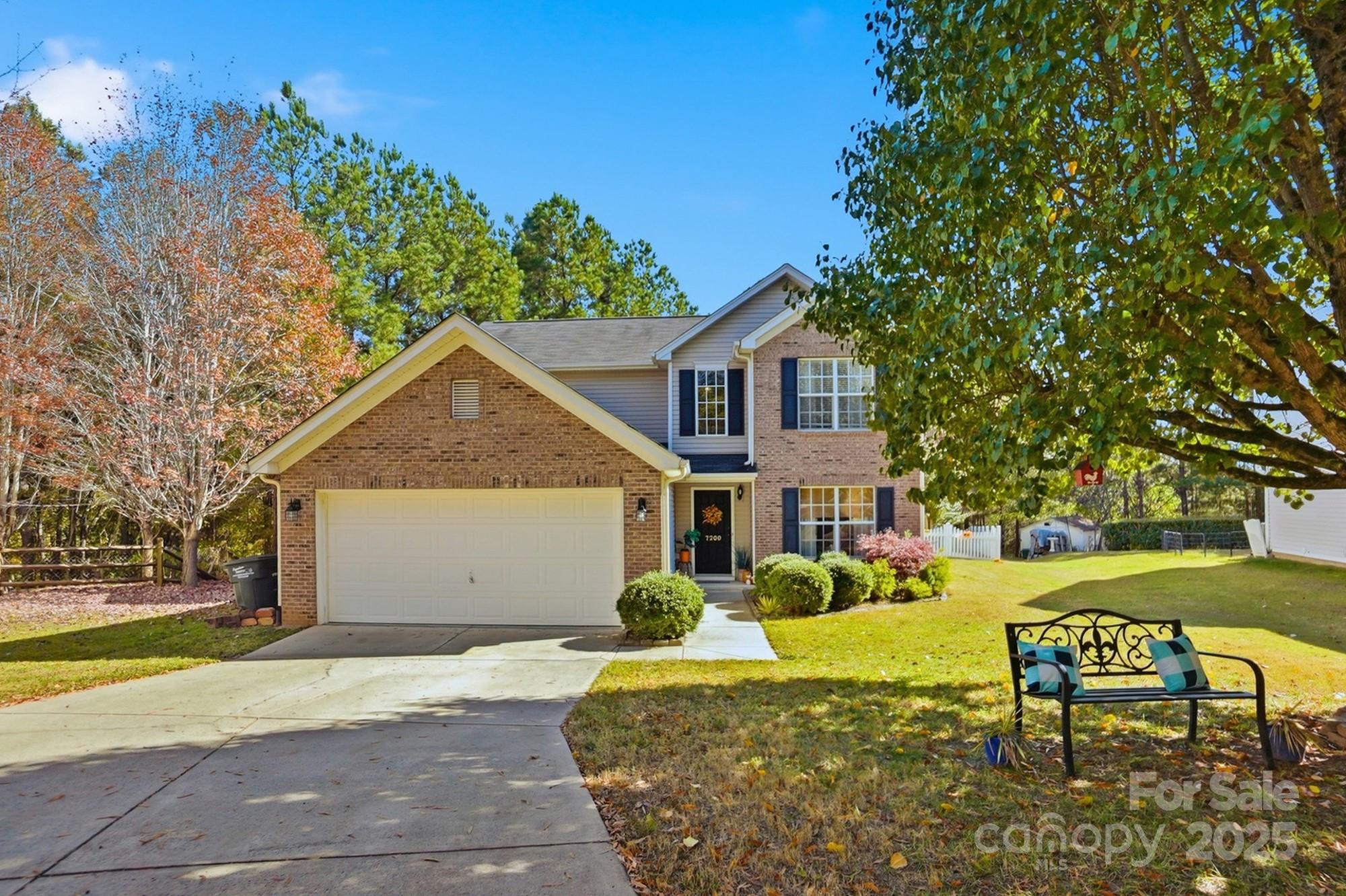 7200 Cascading Pines Drive Tega Cay, SC 29708 - Photo 1 of 39 a front view of a house with a yard garage and outdoor seating
