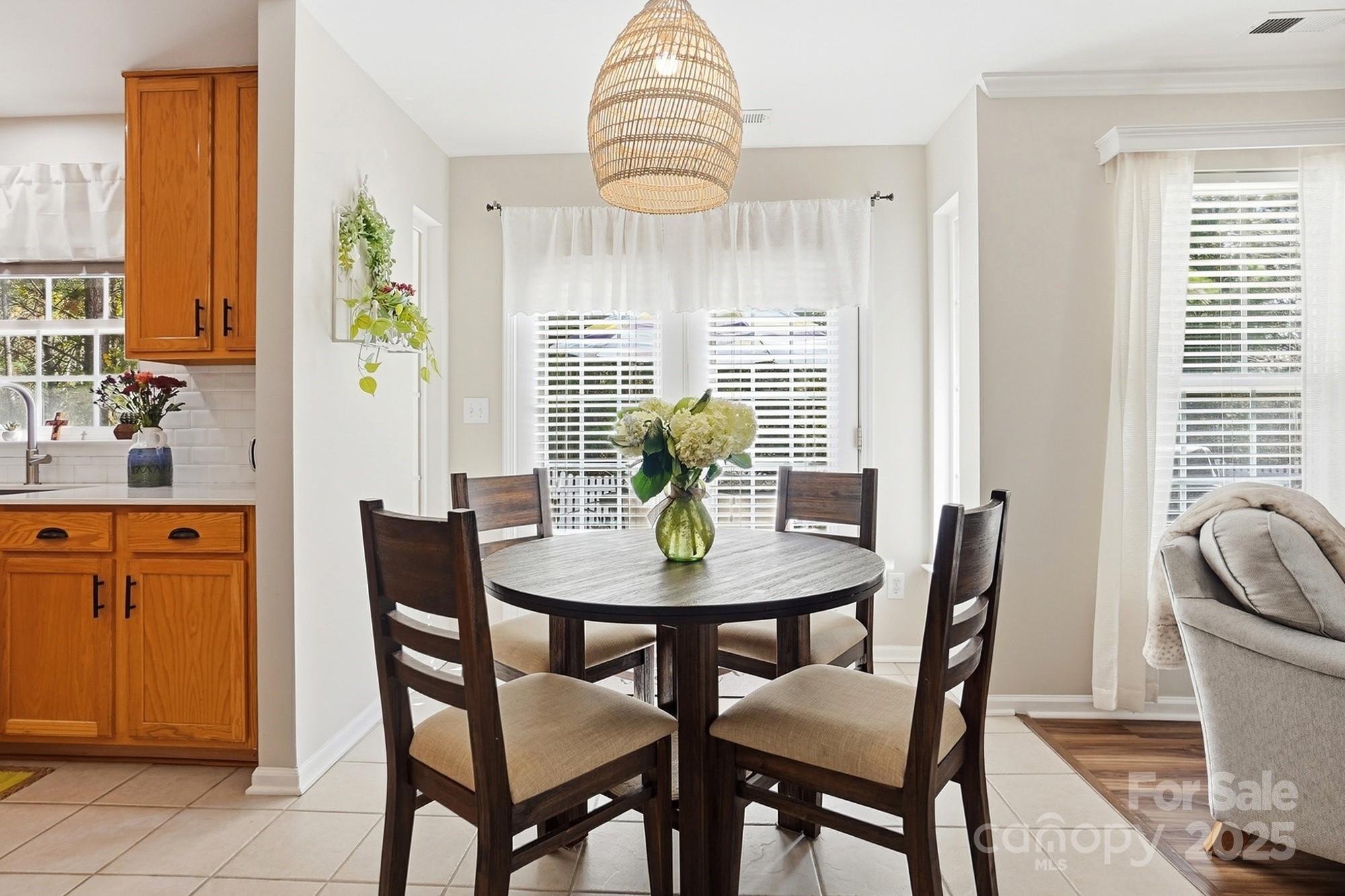 7200 Cascading Pines Drive Tega Cay, SC 29708 - Photo 18 of 39 a view of a dining room with furniture window and wooden floor