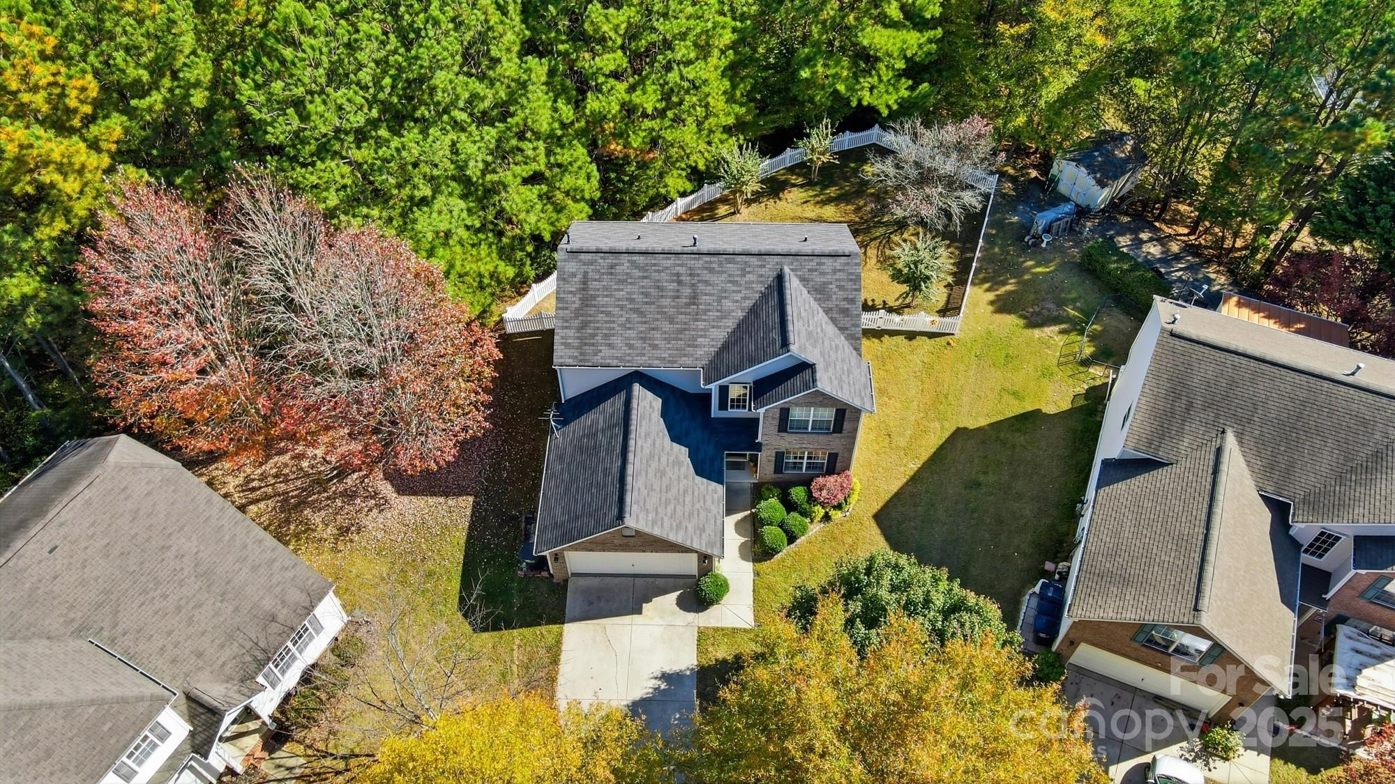 7200 Cascading Pines Drive Tega Cay, SC 29708 - Photo 2 of 39 an aerial view of a house with swimming pool and large trees