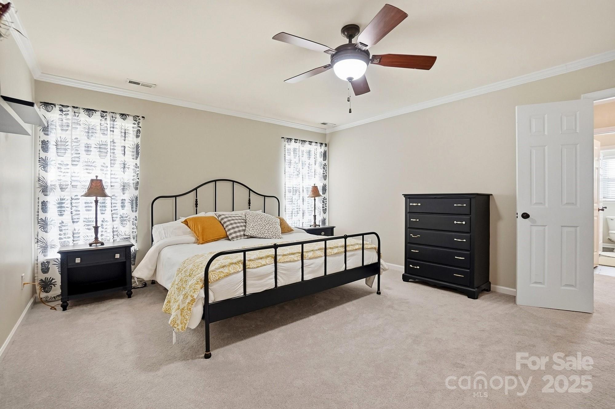 7200 Cascading Pines Drive Tega Cay, SC 29708 - Photo 23 of 39 a bedroom with a bed lamp and a window