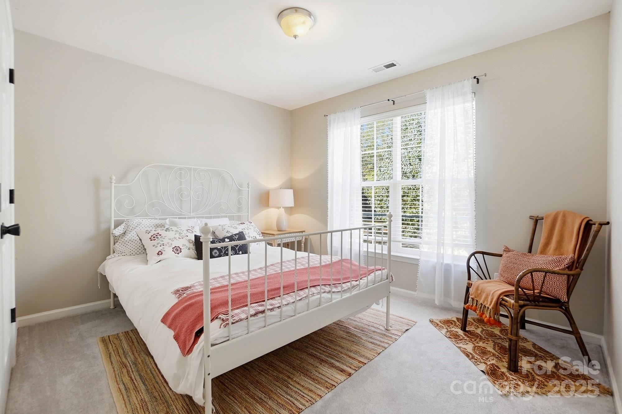 7200 Cascading Pines Drive Tega Cay, SC 29708 - Photo 26 of 39 a bed room with a bed and a chair