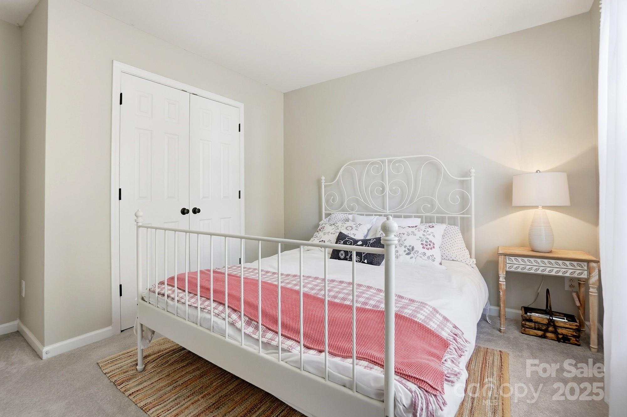 7200 Cascading Pines Drive Tega Cay, SC 29708 - Photo 27 of 39 a bedroom with a bed and a lamp