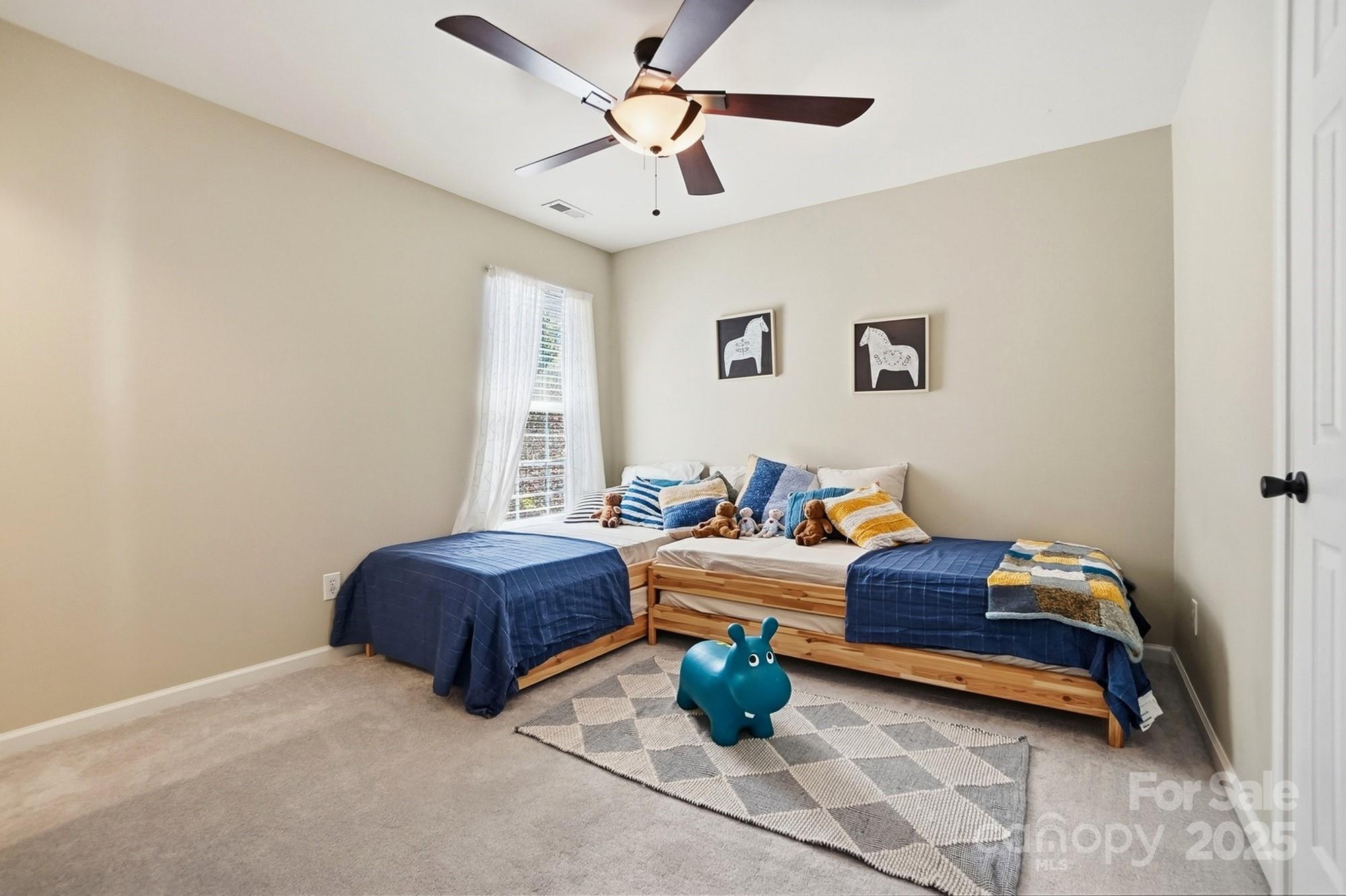 7200 Cascading Pines Drive Tega Cay, SC 29708 - Photo 30 of 39 a bedroom with furniture and window
