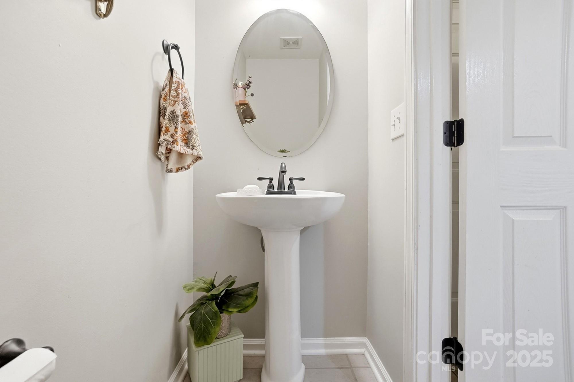 7200 Cascading Pines Drive Tega Cay, SC 29708 - Photo 32 of 39 a bathroom with a sink and mirror