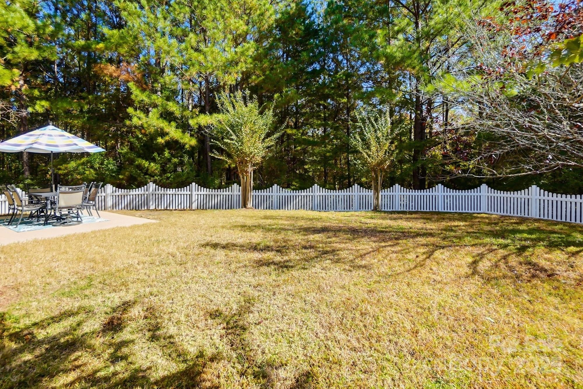 7200 Cascading Pines Drive Tega Cay, SC 29708 - Photo 37 of 39 a swimming pool with outdoor seating and yard