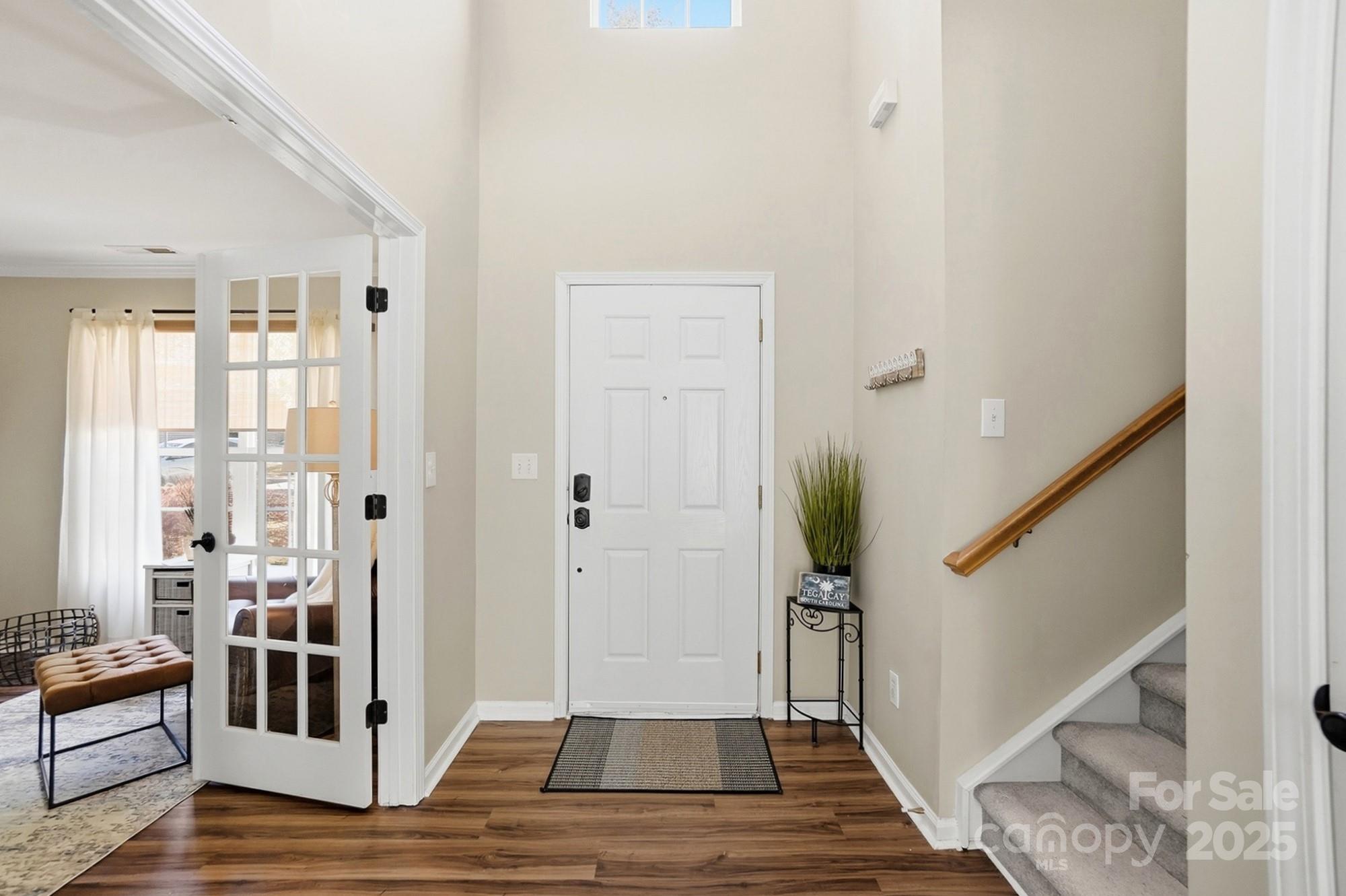 7200 Cascading Pines Drive Tega Cay, SC 29708 - Photo 7 of 39 a view of a hallway with wooden floor and stairs