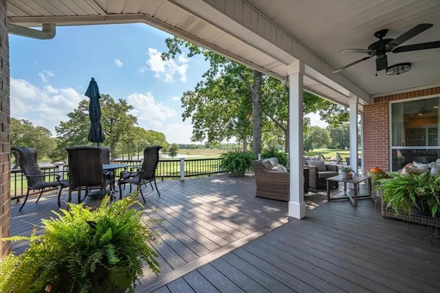 a view of a porch with chairs and backyard