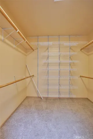 a backyard of a house with basket ball court and wooden fence