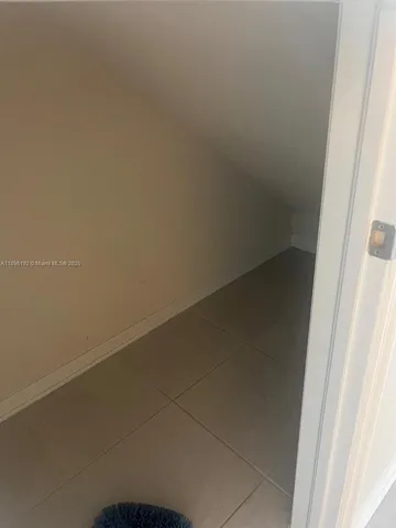 a view of an empty room and a window