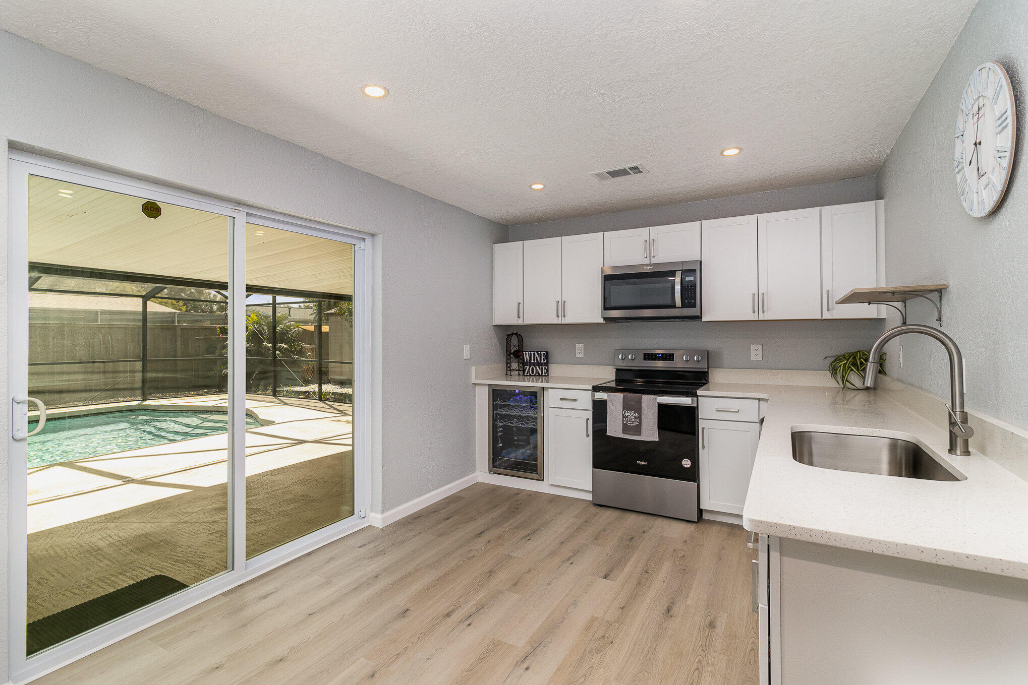937 Kings Post Road Rockledge, FL 32955 - Photo 13 of 24 a kitchen with stainless steel appliances granite countertop a stove top oven a sink and a granite counter top