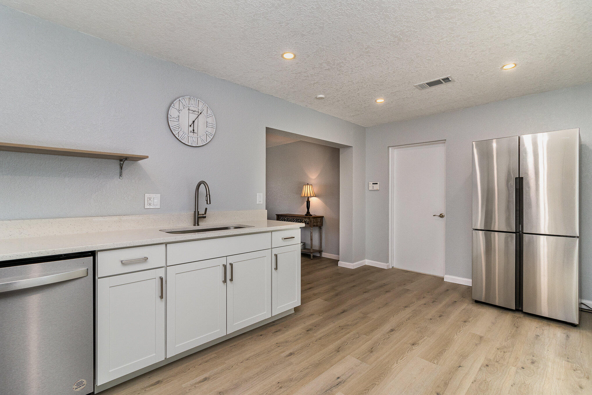 937 Kings Post Road Rockledge, FL 32955 - Photo 14 of 24 a kitchen with white cabinets and stainless steel appliances