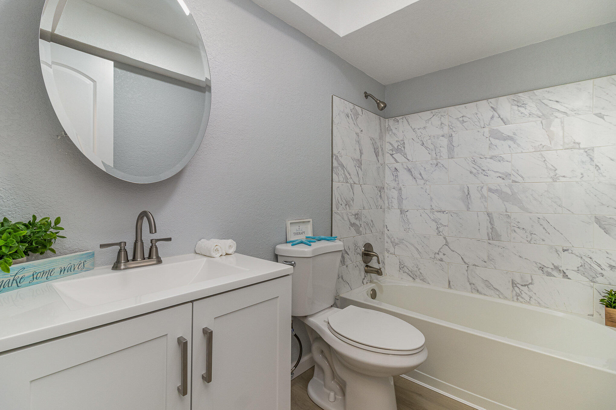 937 Kings Post Road Rockledge, FL 32955 - Photo 16 of 24 a bathroom with a sink a toilet and a mirror