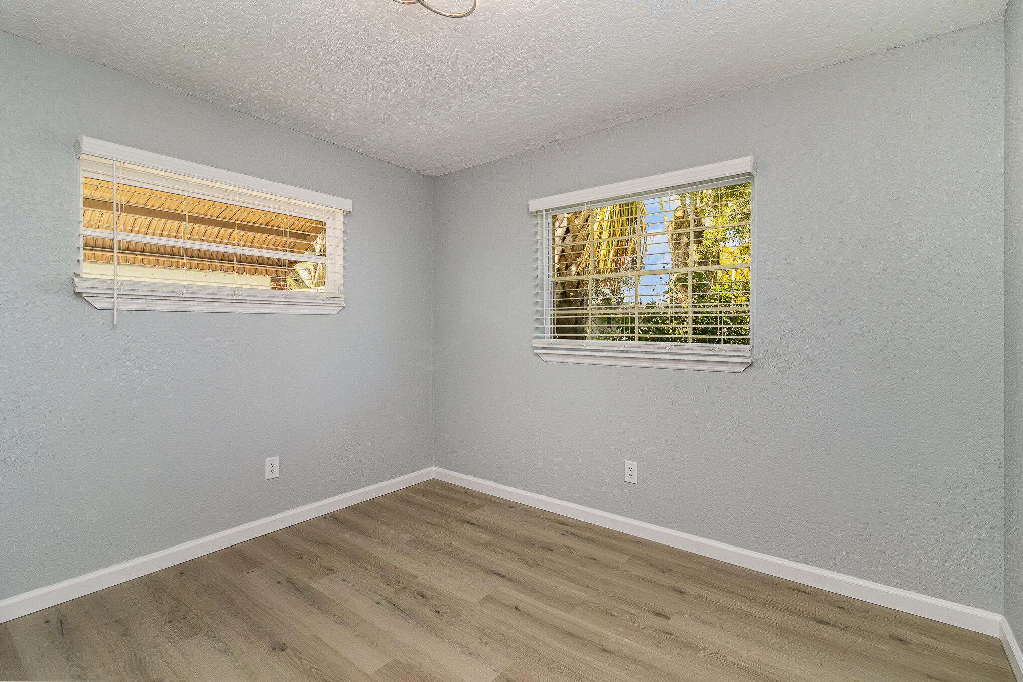 937 Kings Post Road Rockledge, FL 32955 - Photo 17 of 24 a view of an empty room with wooden floor and a window