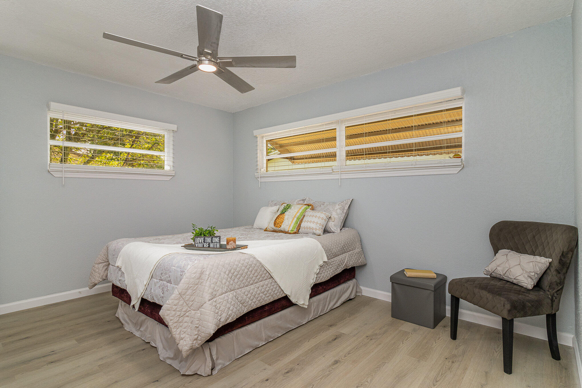 937 Kings Post Road Rockledge, FL 32955 - Photo 5 of 24 a bedroom with a bed and a chair