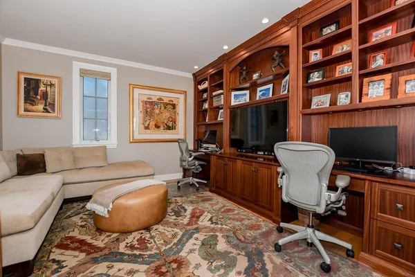 a living room with furniture a piano and a flat screen tv