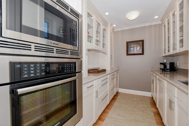 a kitchen with stainless steel appliances granite countertop a stove and a microwave